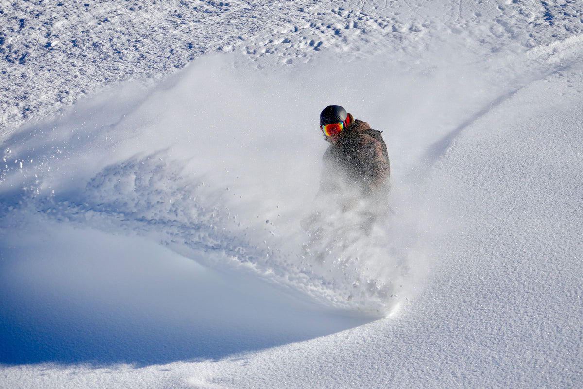 Richard Oldham snowboarding deep powder on his private backcountry mountain in Utah