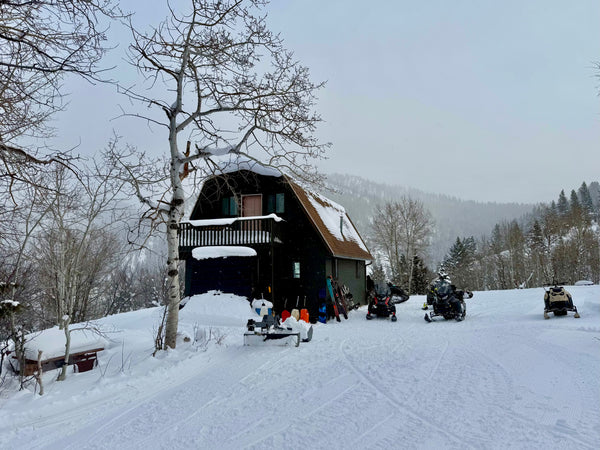 Off-grid cabin with snowmobiles